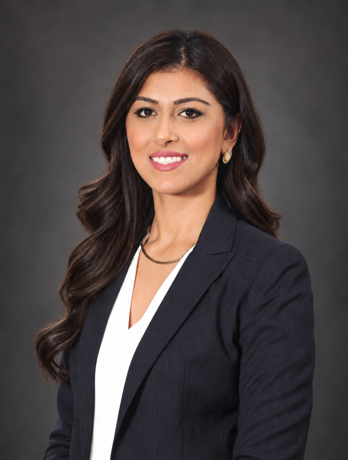 Minsky, McCormick & Hallagan is proud to announce Tahreem Kalam as its newest Shareholder. 2 Woman with long dark hair wearing a black blazer and white top poses against a dark, plain background, looking at the camera and smiling.